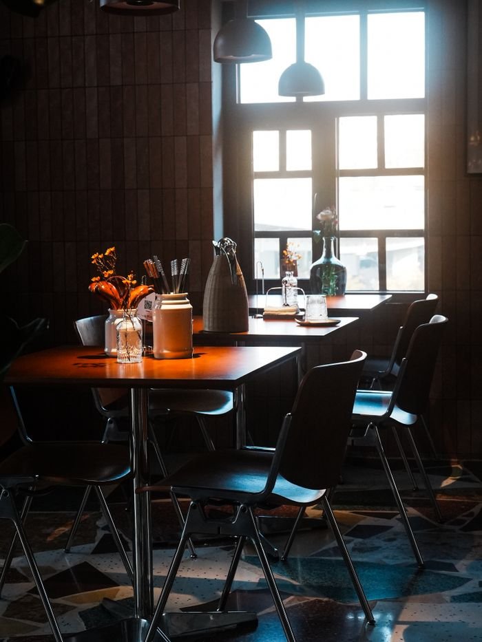 Charming cafe with vintage decor and sunlight streaming through the window.